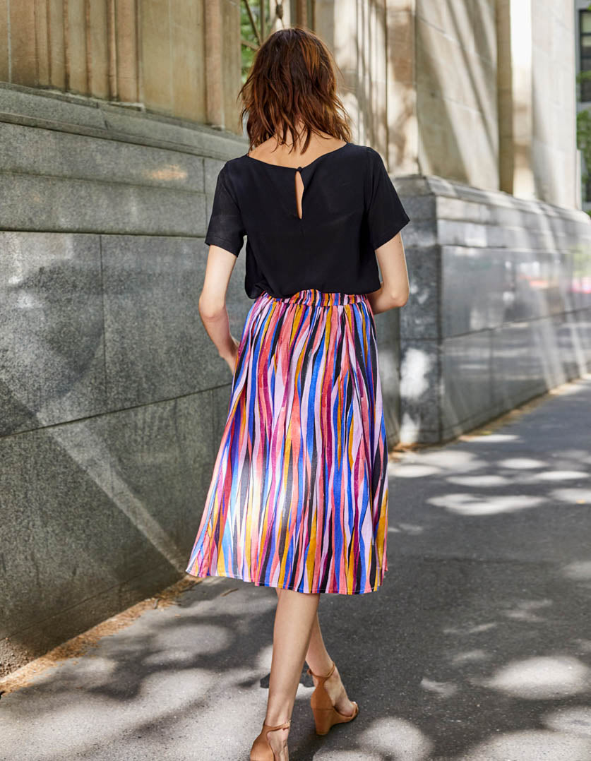 DEVOI Kathleen skirt in the Among The Trees printed linen. Elasticated waist and front pockets. Back view on model