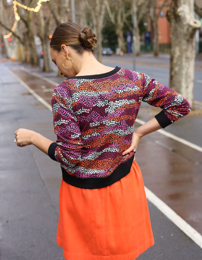 DEVOI Paloma sweater in Black Sediment printed cotton terry. Back view. Black ribbing at hem, cuffs and neckline. 