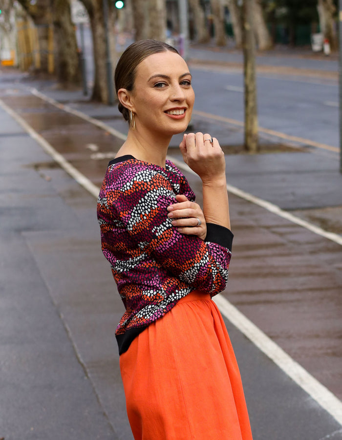 DEVOI Paloma sweater in Black Sediment printed cotton terry. Side view. Black ribbing at hem, cuffs and neckline. 