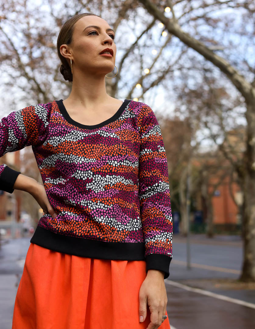 DEVOI Paloma sweater in Black Sediment printed cotton terry. Front view. Black ribbing at hem, cuffs and neckline. 