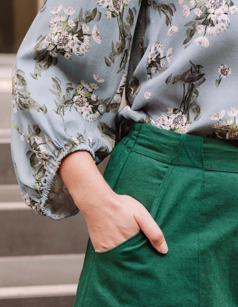 DEVOI Bea top. Blue floral printed long sleeved top with modal crepe. Close-up view on model.