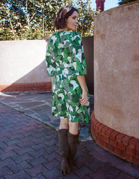 DEVOI wrap dress printed Calla Lilies green. Back view on model