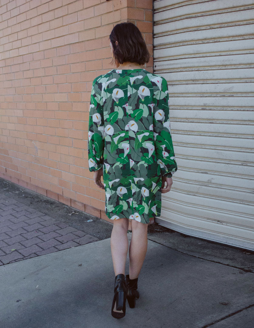 DEVOI Georgia dress in Calla Lilies green print. Knee length with full length sleeves. Back view
