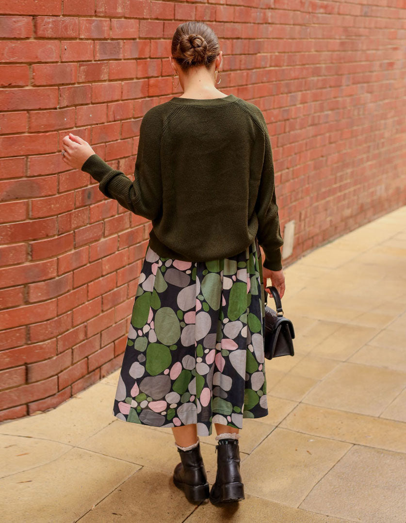 DEVOI Printed Kathleen linen skirt in a green pebbles print. Midi length with pocket and an elasticated waistband. Back