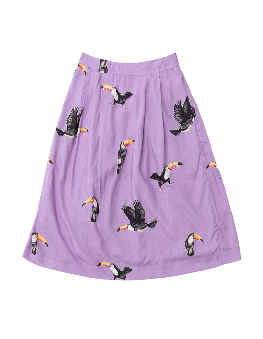 DEVOI Lilac I Can Toucan printed Margot skirt. Midi skirt with a back elasticated waistband and pockets. Front flat lay view