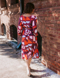 DEVOI Sybille dress in Block Party printed rayon. Back view.