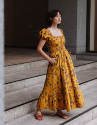 DEVOI Keira dress in Scalavender printed Modal crepe. Smocked bodice and a square neckline, puff sleeves, and with a maxi tiered skirt.