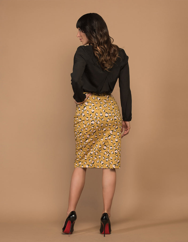 DEVOI Frances skirt in printed Mustard Leopard stretch cotton.  Pencil skirt with pockets, fastened with an invisible zip at the back. Skirt also has a back vent. Back view