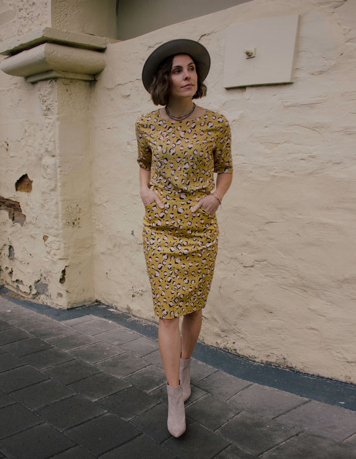 DEVOI Frances skirt in printed Mustard Leopard stretch cotton.  Pencil skirt with pockets, fastened with an invisible zip at the back. Skirt also has a back vent. Front view