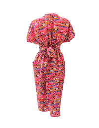 DEVOI Kinsley dress in pink Mosaic printed linen. Wrap dress with a v-neck and short sleeves. Wide waistband. Patch pockets. Back view.