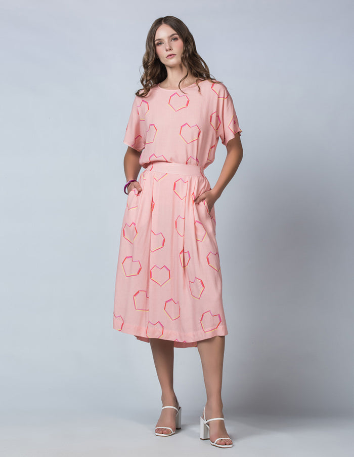 DEVOI Pink Neon Heart printed Margot skirt in modal crepe. Front view on model