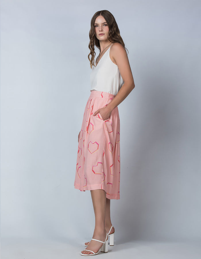 DEVOI Pink Neon Heart printed Margot skirt in modal crepe. Side view on model