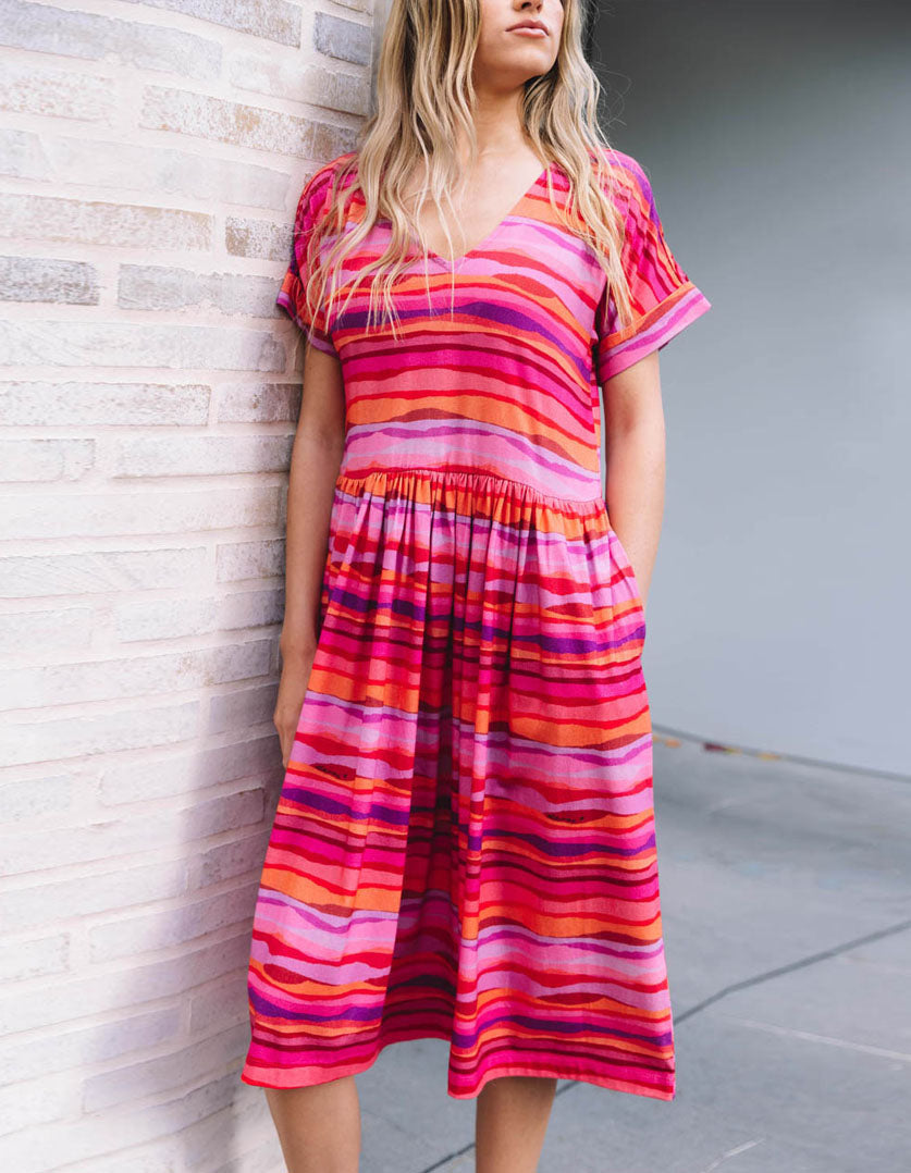 DEVOI Kayleigh dress in Sunset Tide printed 100% Organic Cotton Soft v-neck dress with short sleeves. Finishes just below the knee depending on height. Front side view