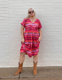 DEVOI Kayleigh dress in Sunset Tide printed 100% Organic Cotton Soft v-neck dress with short sleeves. Finishes just below the knee depending on height. Front full length view