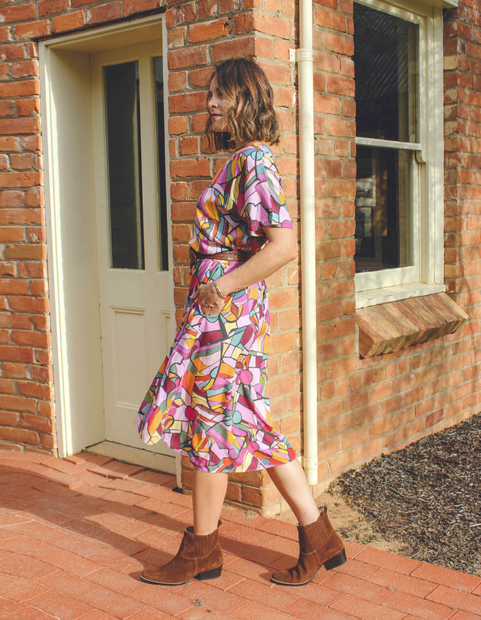 DEVOI Annie dress in Rejoice printed Modal. Belted at the waist and has side pockets! Side view on model.