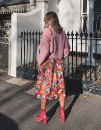 DEVOI Rejoice printed Margot skirt in Modal. Elasticated back waist. Flat front waist. Pockets! Finishes just below the knee. Seen on model. Back view