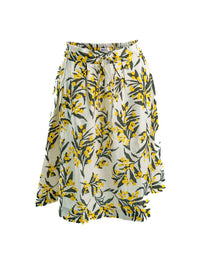 DEVOI Kathleen skirt in golden wattles print. White background with yellow and black. Skirt has pockets and an elasticated waistband. Front view.